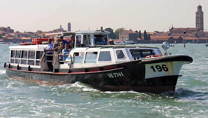 A vaporetto water bus, carrying passengers between Venice and the island of San Michele