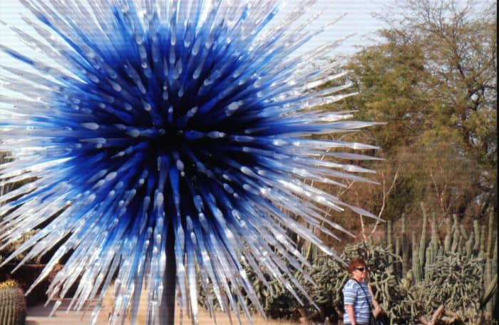 A beautiful sculpture resembling an exploding blue star - "Scarlet and Yellow Asymmetrical Towers" at the entrance to Desert Discovery Loop