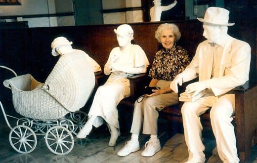 My aunt seated among the life sized figures inside of the Galveston Railroad Museum