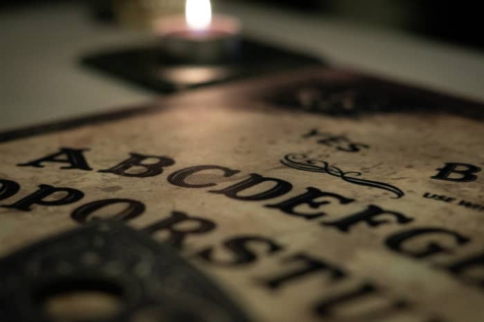 It seems to be a requirement that any image of a Ouija board must have a burning candle in the frame.