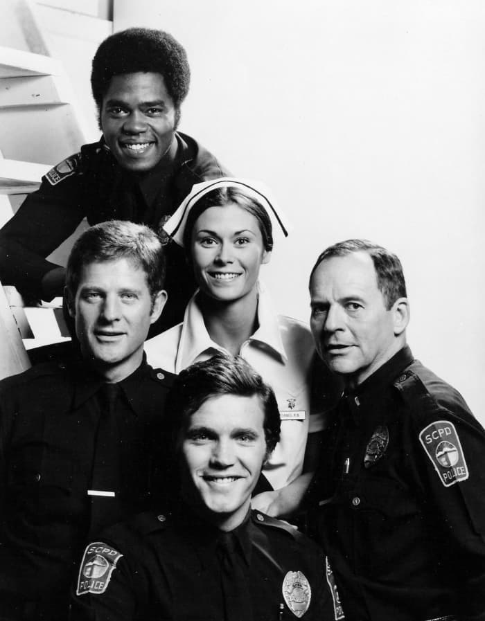 The cast of The Rookies from the top: Georg Stanford Brown (as Terry Webster), Kate Jackson (Jill Danko), Gerald S. O'Laughlin (Eddie Ryker), Bruce Franklin (Chris Owens), and Sam Melville (Mike Danko).