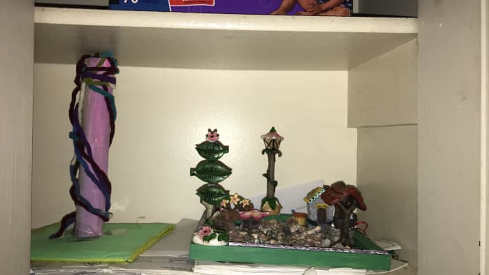 This is the May Pole and rock garden I made as an offering for the Good Folk! The garden was made of a plank of wood, and then Fairy Garden supplies I found at Big Lots