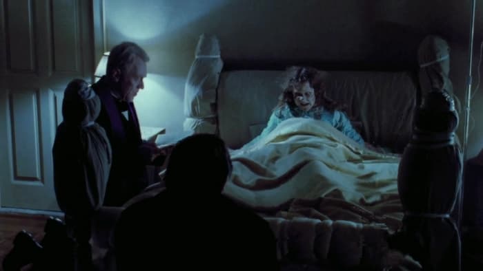 Fathers Lankester Merrin (Max Von Sydow) and Damien Karras (Jason Miller) with Regan MacNeil (Linda Blair)