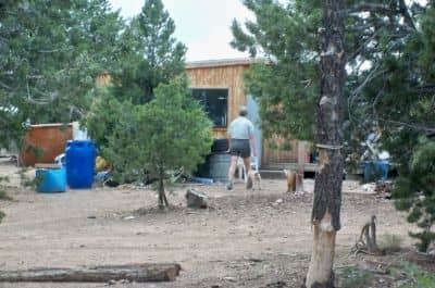 SueAnne checks to see if anyone is home at the gate. No one's around, but she gets nipped in the calf by the puppy.