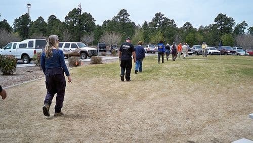 Pacing for Land Navigation. Here, you see students in an alt. nav. class determining their pacing by averaging their results from a 100-foot distance.