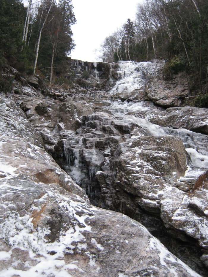 Beyond the waterfall, the slide grows steep with great crevices punctuating the landscape.