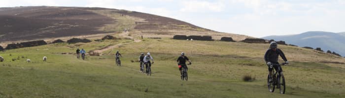 Cycling related testis pain can be a problem, but with a little adjustment it usually can be resolved. (Featured- Riders at Losehill in the Peak District)