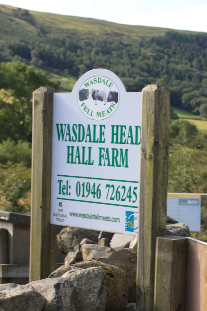 The sign for Wasdale Head Hall Farm is beside the access to the Wasdale National Trust car park