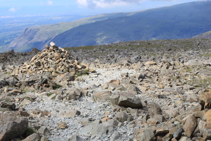 Heading back down following the cairns with breathtaking views of the Lakeland Fells