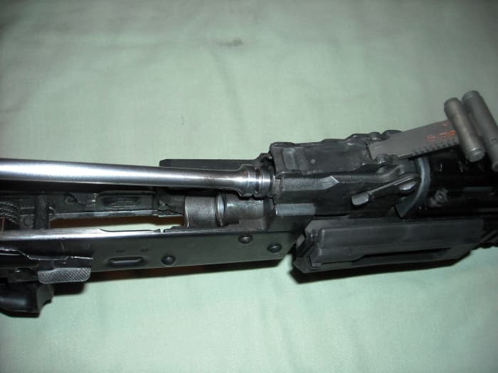 While holding the bolt carrier group in your hand, insert the gas piston end of the bolt carrier group into the gas piston chamber.