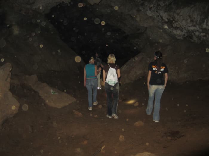 In one of the bigger areas inside Peppersauce Cave, Arizona. Brown spots are dust particles floating in the dry air inside the cave.