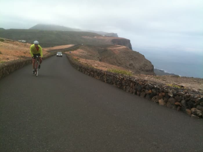 A cyclist climbing the Mirador Del Rio. The rugged yet beautiful Mirador Del Rio climb offers amazing views to La Isla Graciosa