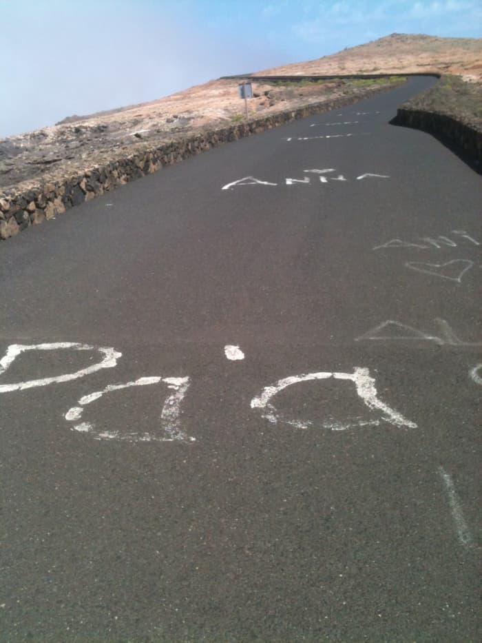 The climb to the Mirador Del Rio features in Ironman Lanzarote and specators write words of encouragement on the roads to inspire racers