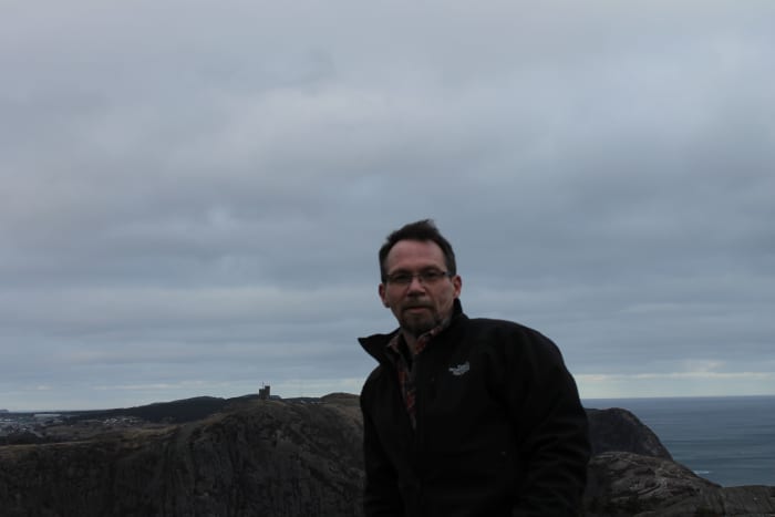 The author on Deadmans Bay Path at Soldiers Pond on the East Coast Trail. Cabot Tower, on Signal Hill, is just visible in the background.
