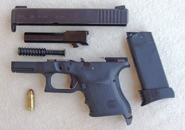 Glock Field Stripped. Note Fewer And Simpler Parts; P-35 Style Under Barrel Cam And Barrel Feed Ramp