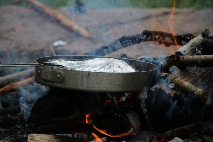 Cook simple meals when camping with little ones. Mountain pies, grilled cheese sandwiches, and pasta are easy to make and have an easy clean-up when mealtime is done.
