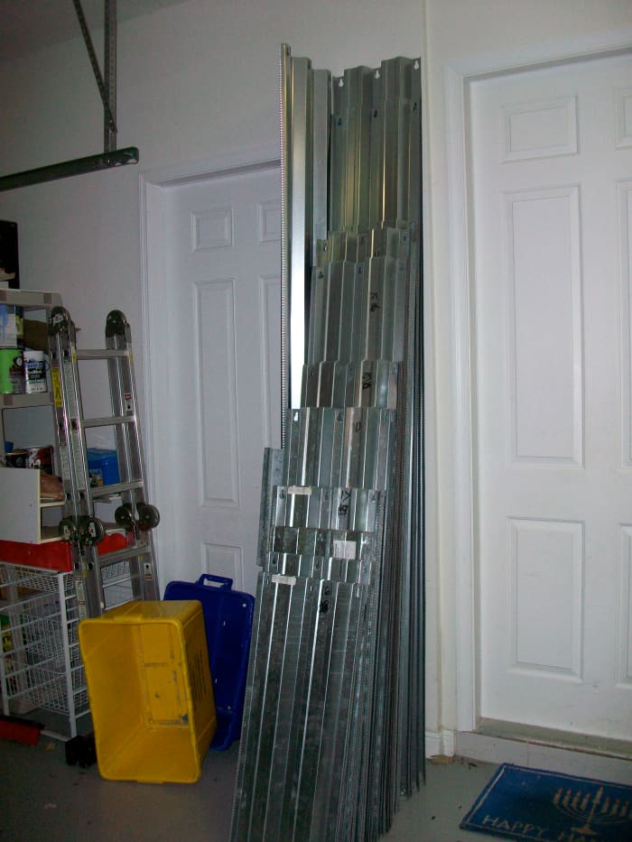 This is several hundred square feet of aluminum storm shutters we donated to our local Habitat ReStore. They carried them out to the truck for us, so no sweating or cutting our hands!