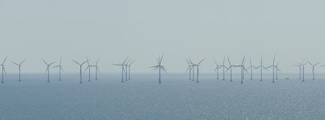 Wind farm. Turbines are used to harness the wind's power. They are an increasingly popular sight, but some local people object to them, arguing that they are ugly and disrupt the environment and quality of life in other ways.