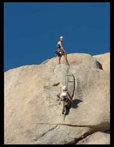 AMGA-certified guide Martry Molitoris, with Alpine Endeavors, belays his client on the JTree classic route, "Toe Jam."