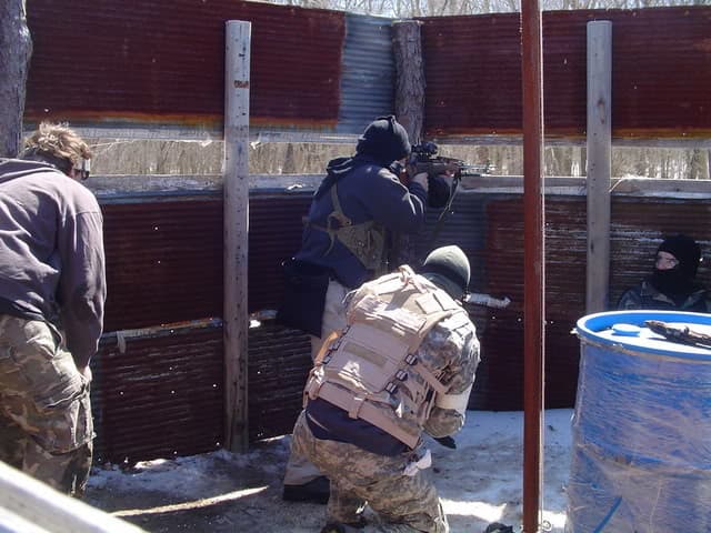 The person in the middle of this image is using a scoped RPK machine gun at 400 FPS, with a 3000-round drum magazine. Going against this with a sniper rifle is simply ridiculous.