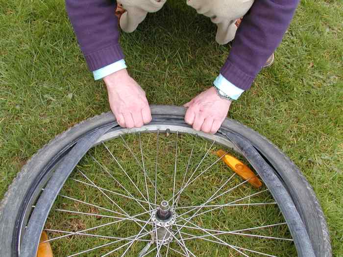 Feed the tube into the tire and thread the valve through the hole in the rim