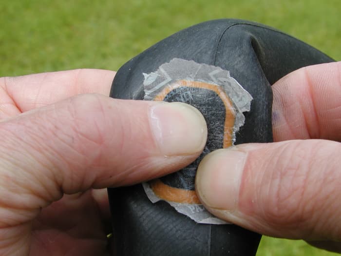 Push down hard on the center first and then towards the edges to expel any air. The paper (if attached) helps to stop the patch sticking to the tire.