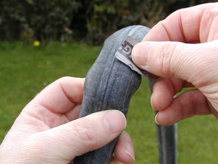 Sandpaper the area around the hole to roughen it and ensure the patch bonds well to the tube