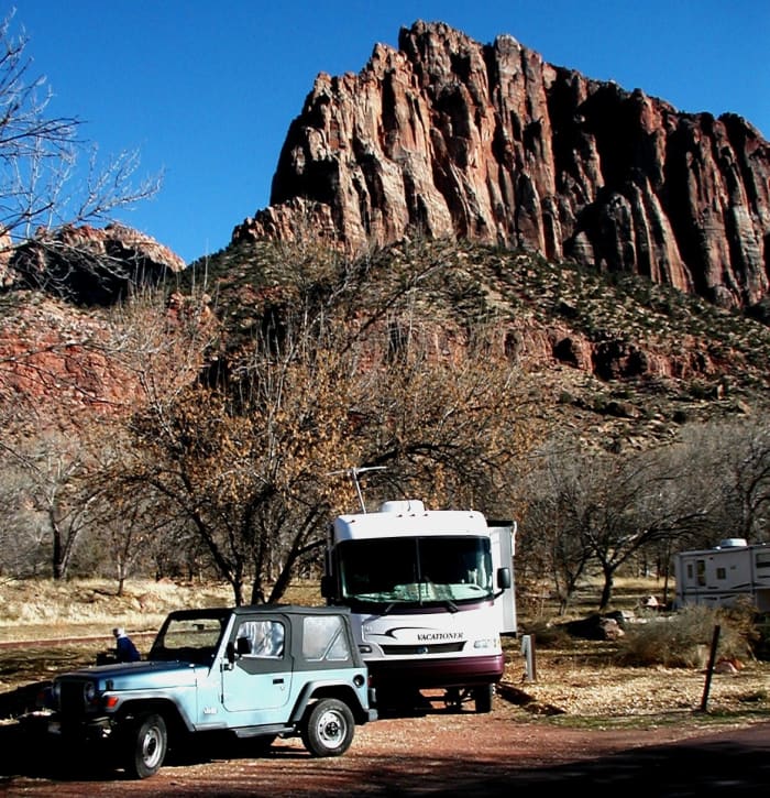A perfect off-the-grid campsite at Zion National Park with beautiful rock formations in the background.