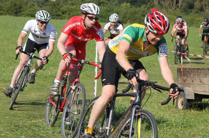Racing Around a Grassy Corner. In Red: Cyclocross Racing on a Planet X Uncle John With Mavic Ksyrium Wheels and Challenge Grifo Pro Clincher Tires