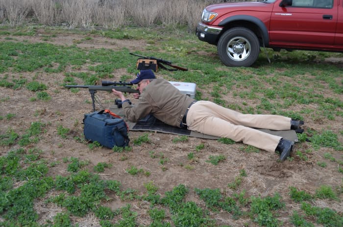 Aiming at a distant jackrabbit, the Harris bipod on this .223 bolt action rifle is an asset.