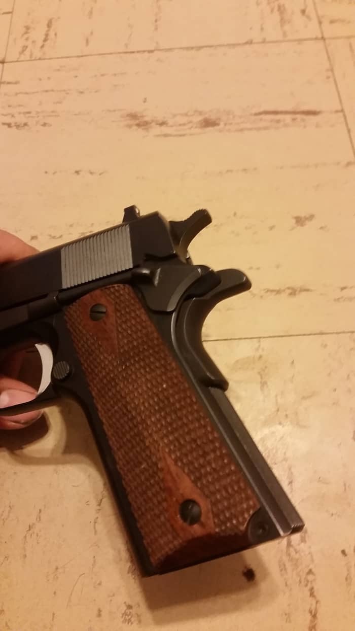 Showing off the nice fit of the walnut grips and the flat main spring housing. You can also see the A1 style trigger and grip safety.