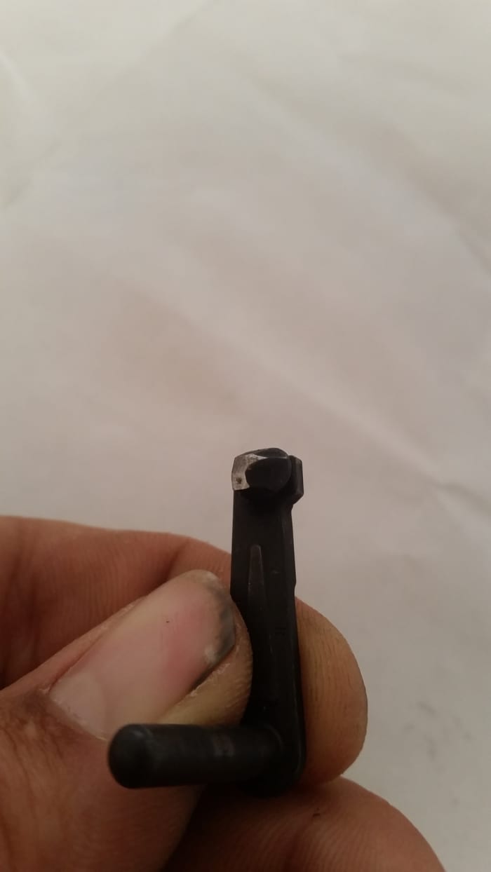 Showing how much metal I had to file off of the slide stop. The two angles used to come together to form a point which I filed off.