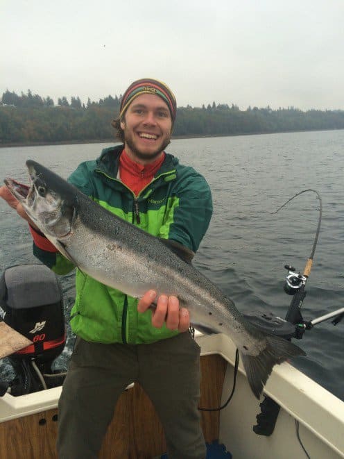 A Coho I caught while trolling on a downrigger. Notice the full bend placed in the rod in the background.