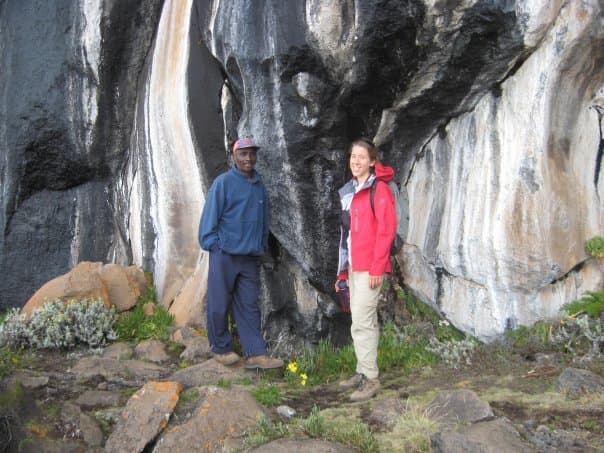 Standing next to Zebra Rocks with our guide, Abasi. The stripes are caused by mineral-rich rainwater that flows over the rock face.