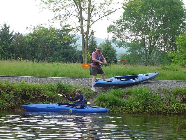 Preparing to take off at the put-in spot. These are good examples of recreational kayaks. Notice the length of the boats and the size of their cockpits.
