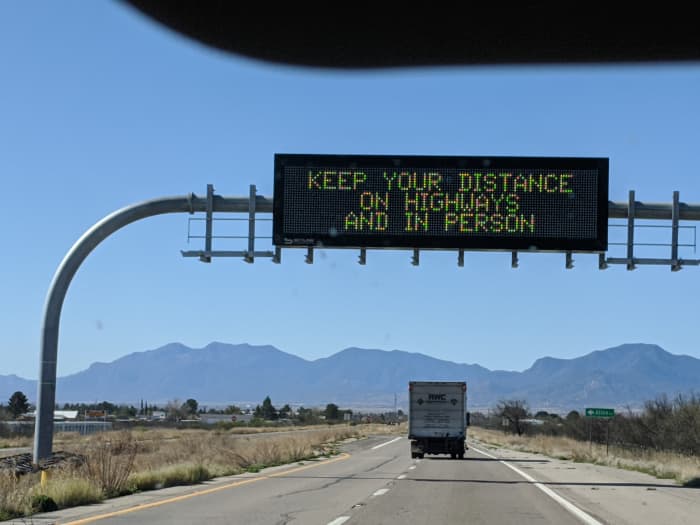 Information Alert Sign on Interstate-10 Alerting drivers to keep safe driving distance to avoid accidents and safe distance from people to avoid COVID-19