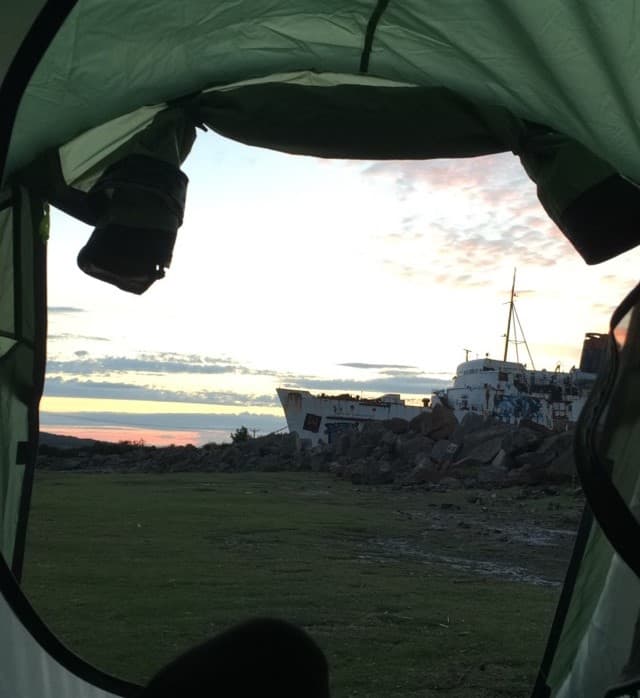 Waking up whilst wild camping next to the TSS Duke of Lancaster ship near Mostyn, North Wales Coast Path