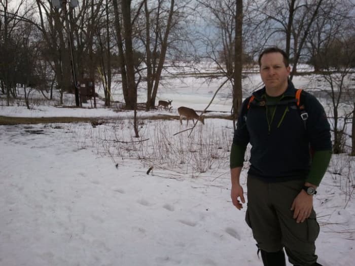 Experience your environment in all four seasons by winter hiking. Notice the deer in the background.