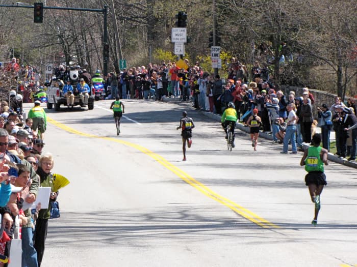 Top 3 men heading up Heartbreak Hill in what would be a record time for winner Geoffrey Mutai of Kenya in 2:03:02 at the 2011 Boston Marathon.