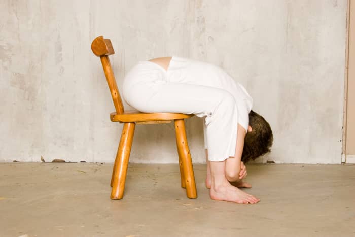 Seated Forward Fold in a Chair. To come into the pose, rag doll down as you exhale, and only come as far forward as feels comfortable for you. If you have high blood pressure, keep the head above the heart and the elbows on the knees.