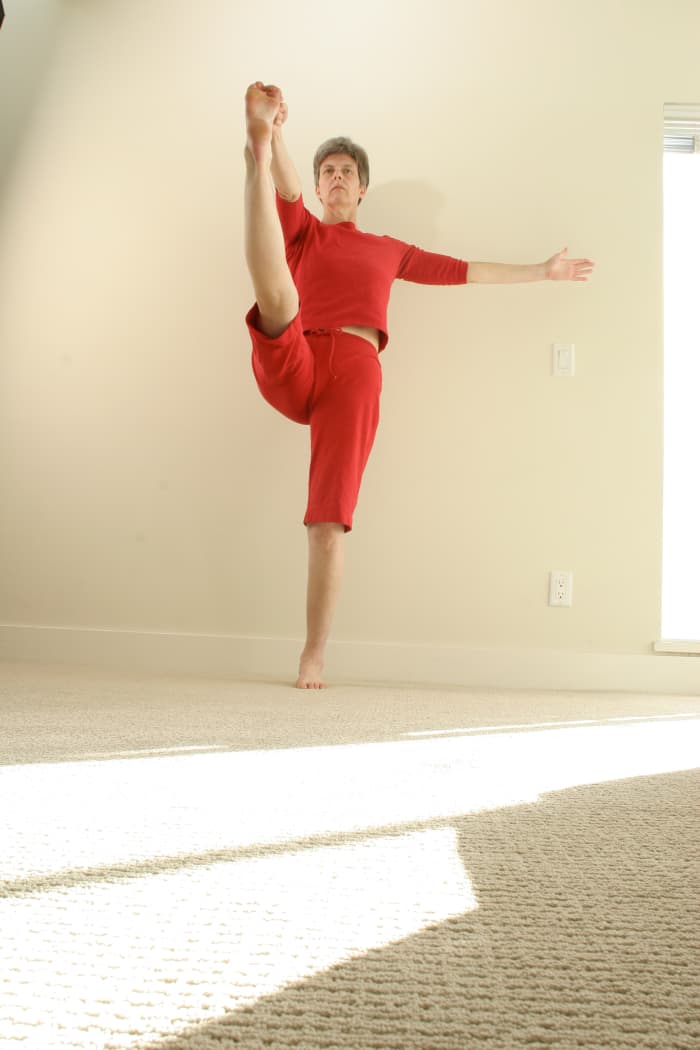 Hand to Toe Posture, or Hastapadmasana, is a challenging standing pose that requires strength, balance and hip flexibility. A simpler variation can be done lying on the back, and using a strap around the foot.