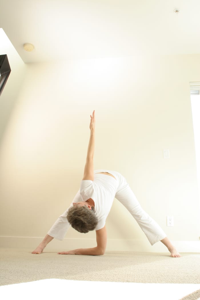 Windmill is a wide-legged forward fold with a twist. Keep the hipbones level, keep lengthening the ribs away from the hips to activate the abdominal muscles, and twist from the root of the spine.