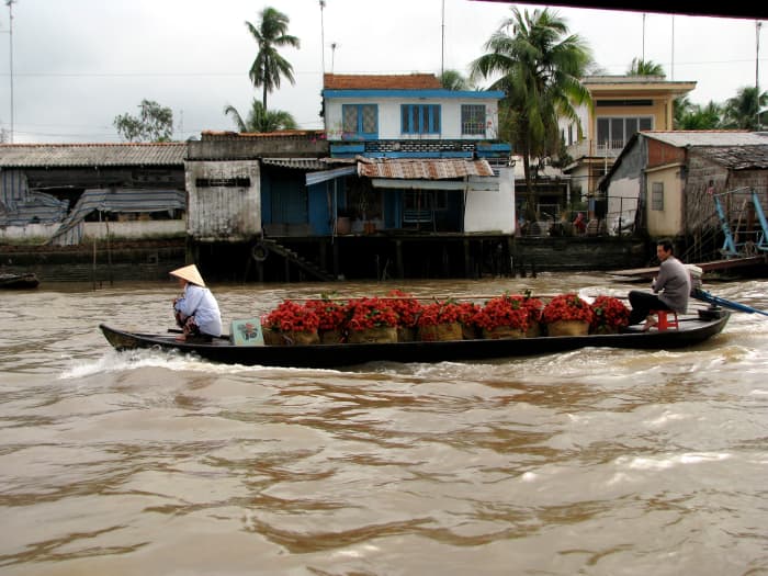Selling the rambutan fruit amongst the various boats, all swapping locally grown fruits and vegetables.
