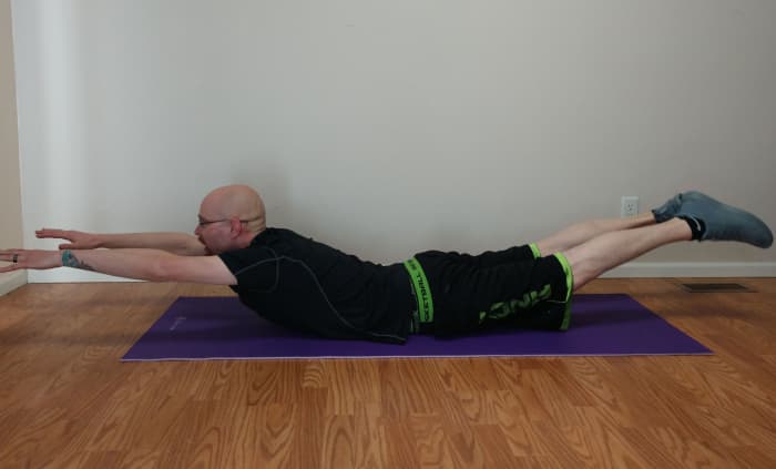 To do the superman exercise, simultaneously raise your arms and legs about 6-15 inches off the floor.