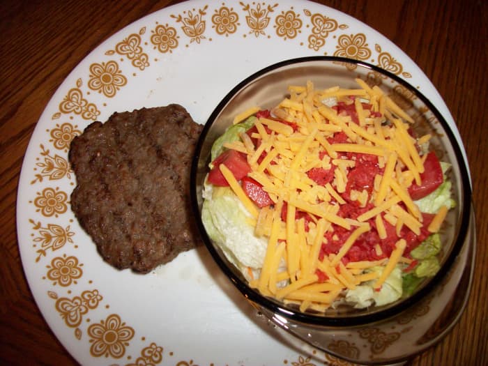 A hamburger patty with no roll and a salad with dressing on the side can be a low-calorie lunch.