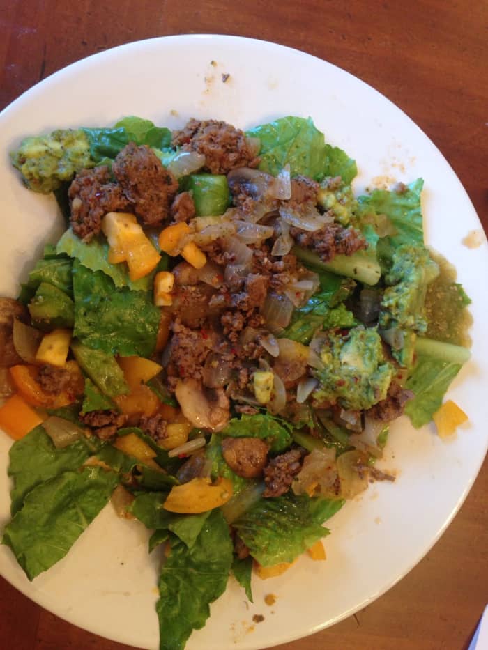 Spicy pepper taco salad: grassfed beef sauteed with mushrooms and onions, leaf lettuce with heirloom tomatoes, simply salsa guacamole, and salsa verde.