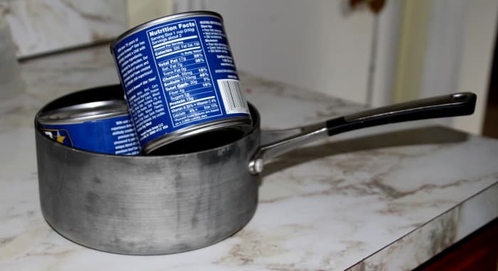 Canned foods inside a cooking pot can be used as free weights.