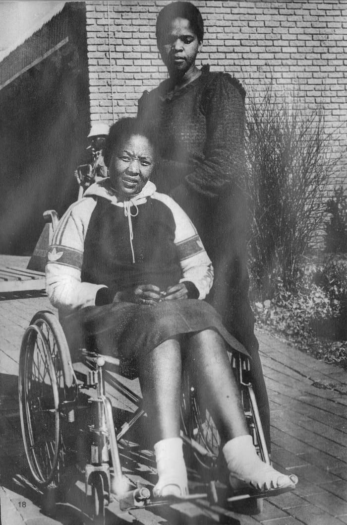 Poppie Buthelezi(on a wheelchair) and Phindile Mavuso, both wounded by police bullets during the Soweto 1976 students revolution