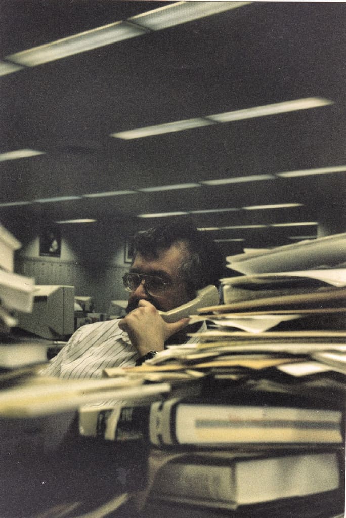News reporters interview by phone these days: Here's a reporter interviewing by phone. Notice how tidy his desk is? This is normal in a newsroom!