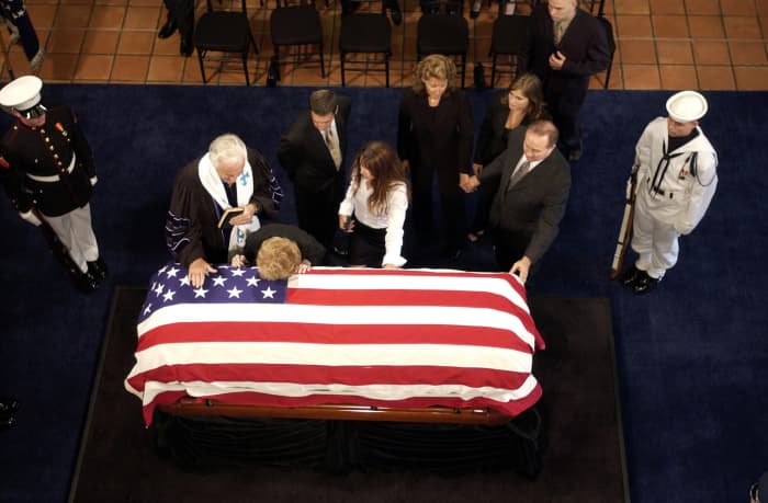 With family members in attendance, Former First Lady Nancy Reagan, lays her head on the flag-draped coffin of her late husband during a service at the Reagan Presidential Library located in Simi Valley, California.